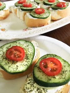 Cucumer and tomato sandwiches on a plate